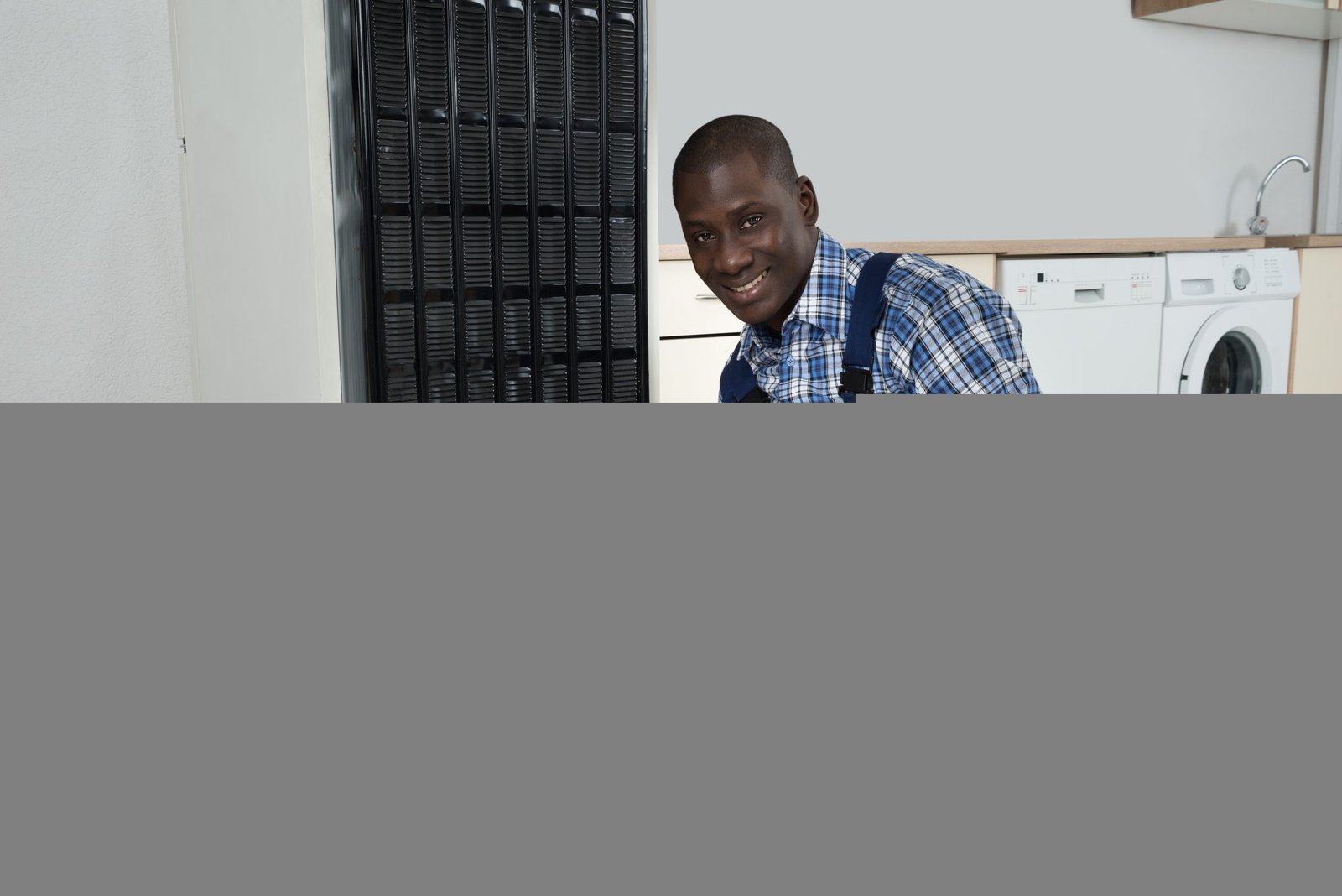 Technician Fixing Refrigerator